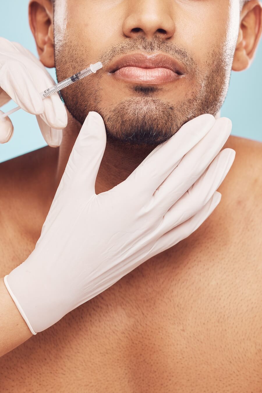 closeup of a mixed race man receiving a botox inje 2023 11 27 05 34 48 utc